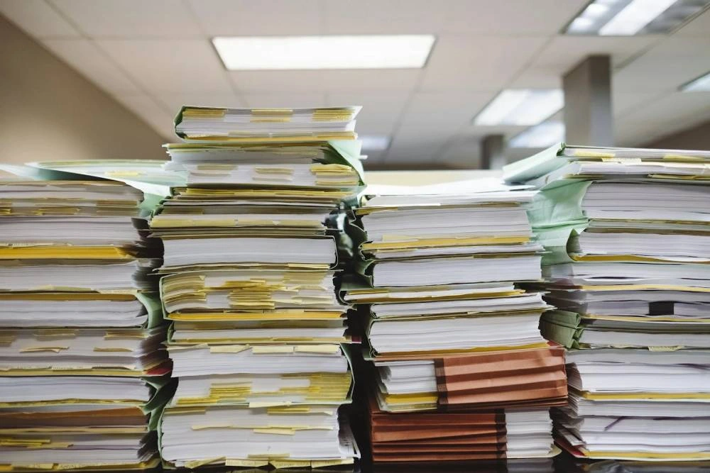 a pile of books on a shelf.