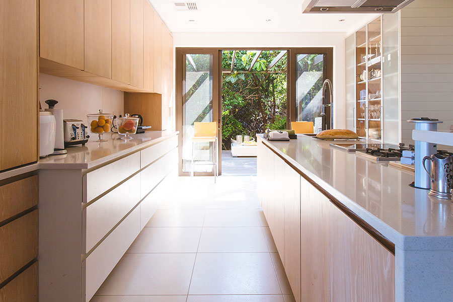 a kitchen with a white counter top and a white refrigerator.