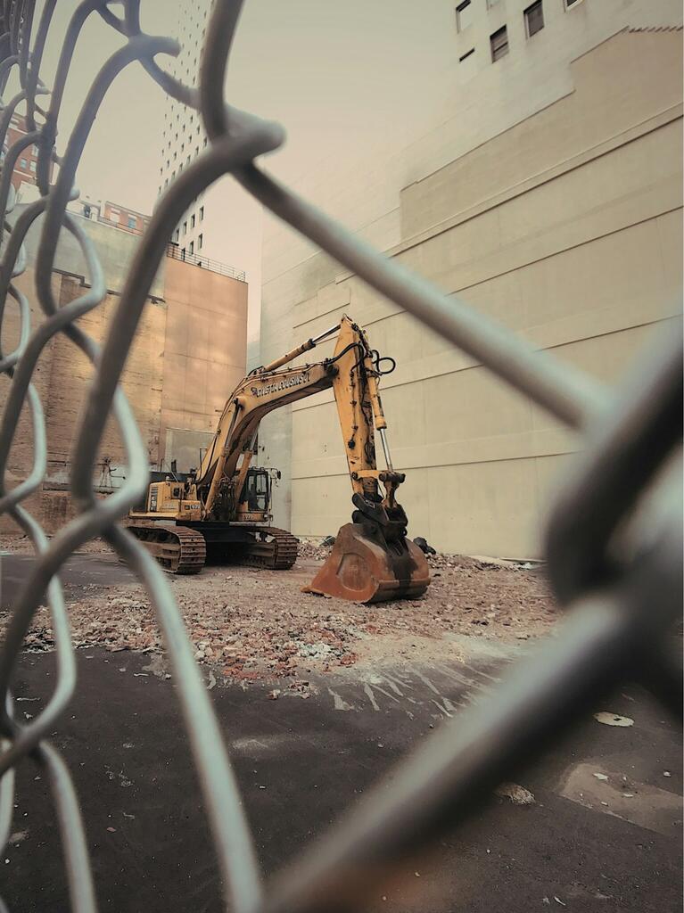 a large metal fence with a large metal object in front of it.