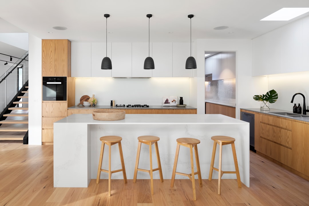 a kitchen with a stove, sink, and cabinets.